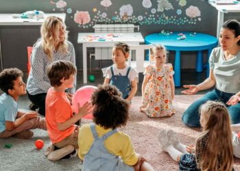 Niños y educadoras sentados en círculo en una escuela infantil privada de Madrid, ejemplo del Cheque Guardería 2025-2026