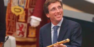 Político español sonriente con traje sosteniendo bastón de mando en acto oficial, ilustración sobre los salarios públicos de alcaldes y otros cargos políticos en España