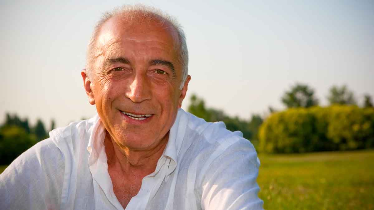Hombre mayor sonriente al aire libre simboliza seguir cobrando el paro tras la edad de jubilación según el SEPE