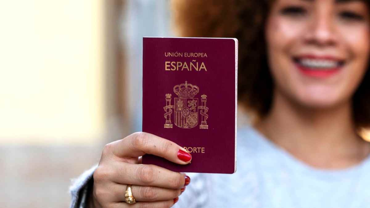 Mujer mostrando un pasaporte español; plazo Ley de Nietos hasta 22 octubre 2025