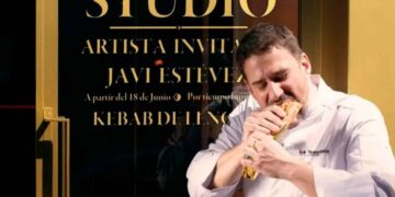 Chef Javi Estévez comiendo un kebab de lengua frente al escaparate de La Tasquería en Madrid