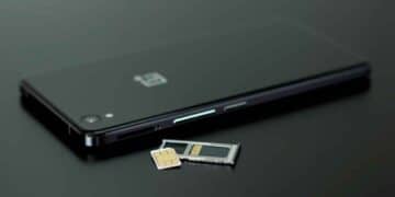 Teléfono móvil negro con bandeja y tarjeta SIM extraídas, ilustrando la transición a la nueva eSIM integrada