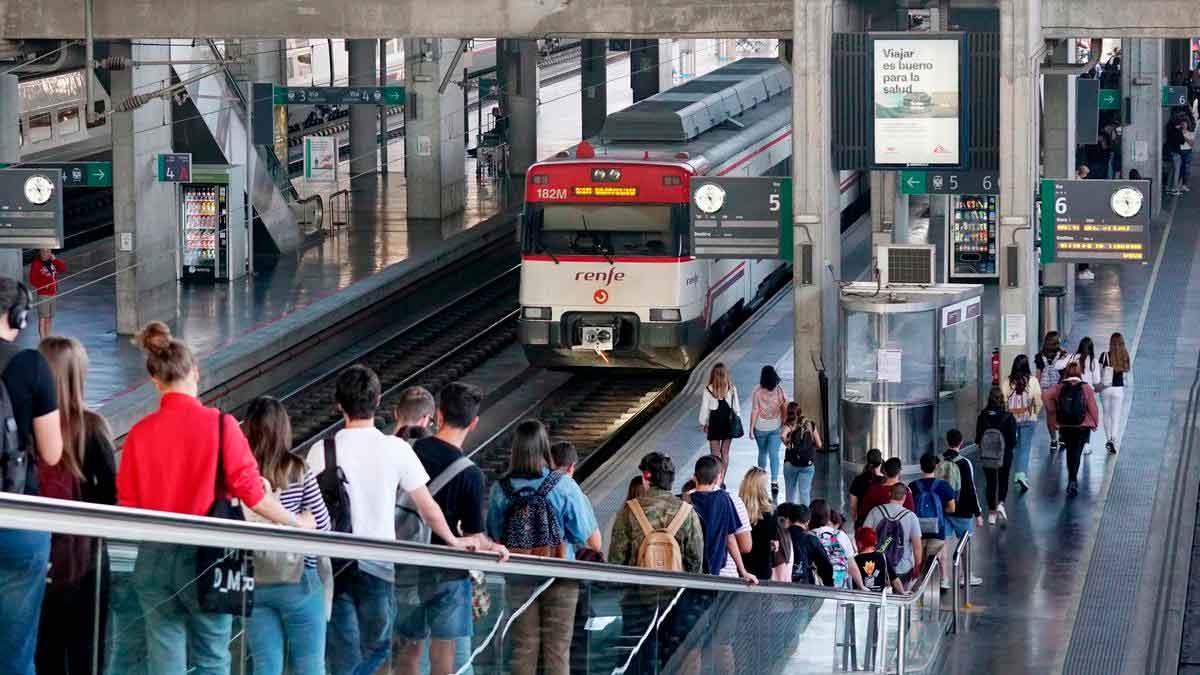 Pasajeros esperan en una estación de Renfe mientras llega un tren de cercanías, ejemplo de la nueva gratuidad del transporte público para menores de 15 años y descuentos de hasta el 70 % para el resto de usuarios