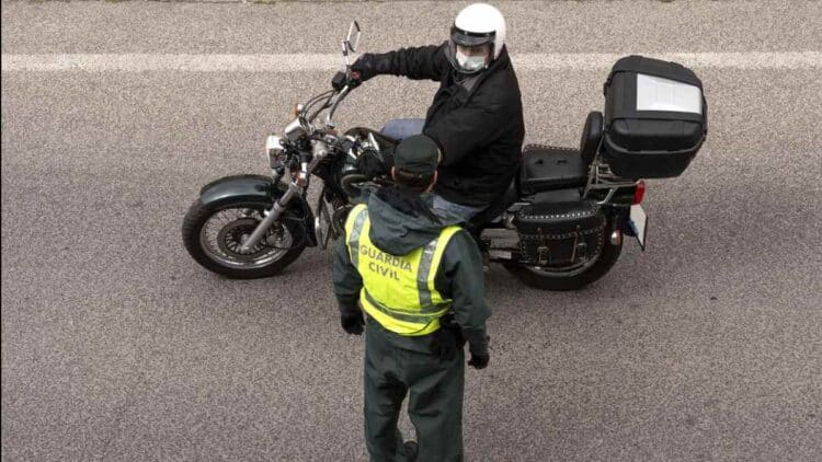 Guardia Civil controla a un motorista en un tramo de carretera en obras.