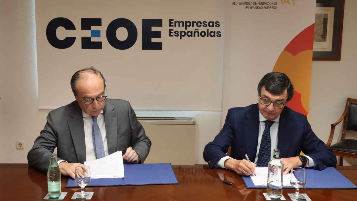 Empresarios firmando acuerdo en CEOE sobre indemnizaciones por despido tras decisión del Supremo.