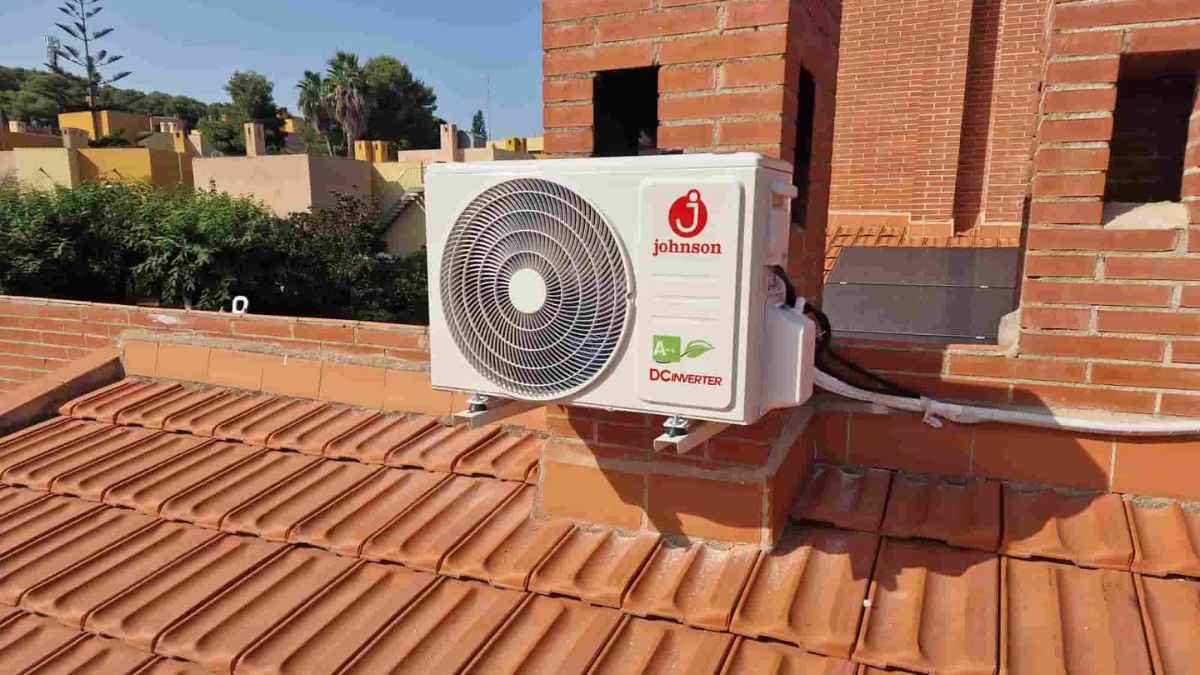 Unidad exterior de aire acondicionado instalada incorrectamente en una azotea expuesta al sol