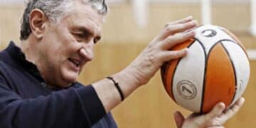 Fernando Romay, exjugador de baloncesto, sostiene un balón mientras explica su lucha por una pensión digna tras no poder cotizar durante su carrera.