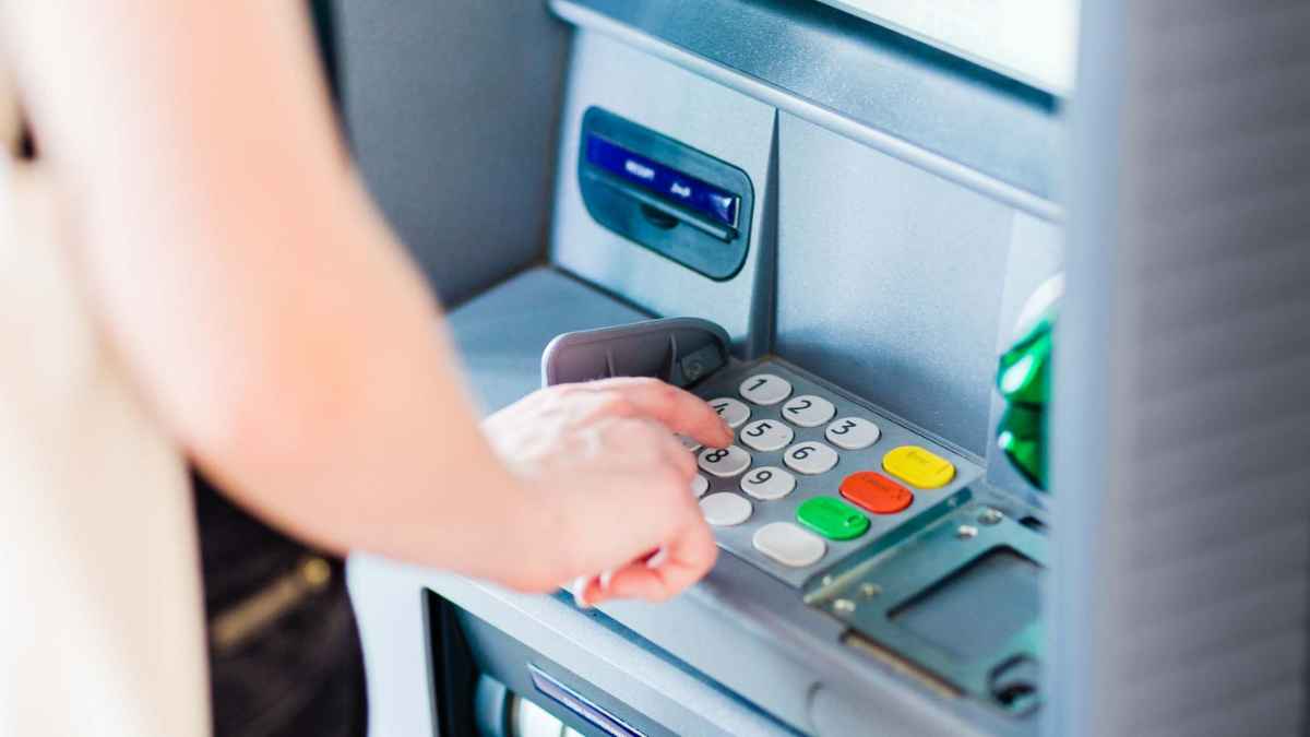 Persona sacando dinero del cajero tras el consejo de la OCU sobre límite máximo seguro en la cuenta bancaria