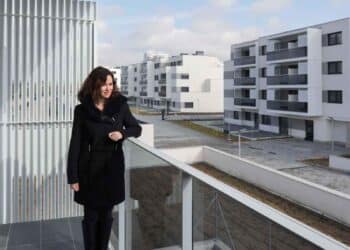 Ayuso en el balcón de una vivienda nueva en Madrid, relacionada con el registro para vivienda protegida.