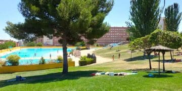 Piscina en Madrid con espacio verde ideal para refrescarse durante el verano, disfrutando de un día soleado y caluroso.