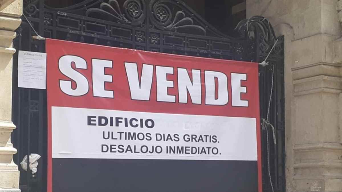 Cartel de se vende edificio con aviso de desalojo inmediato en plena crisis de vivienda.