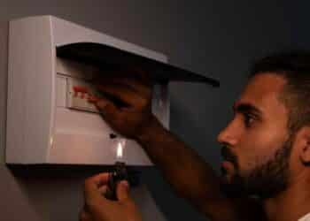 Hombre revisando cuadro eléctrico durante un corte de luz en Madrid por mantenimiento de Iberdrola.