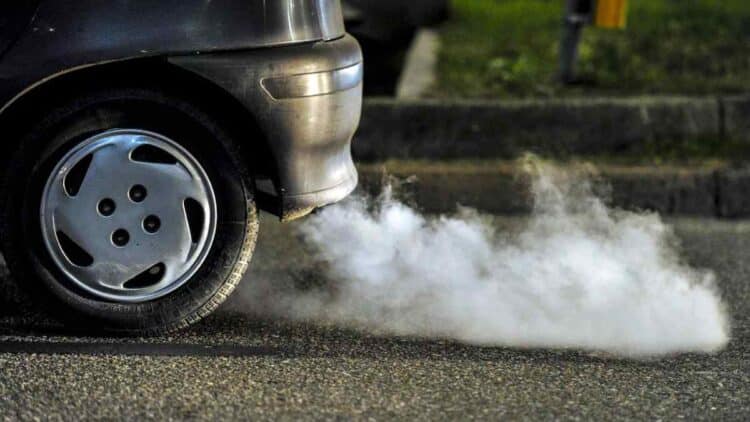 Coche diésel antiguo expulsando humo por el tubo de escape en España.