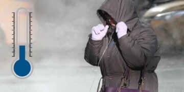 Persona abrigada durante la ola de frío en Madrid con temperaturas mínimas de 2 grados y lluvias intensas.