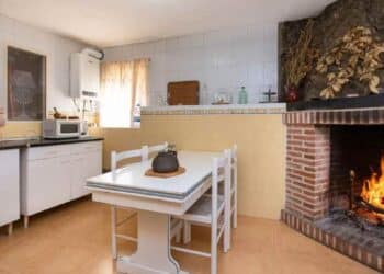 Cocina rústica con chimenea en casa en venta en Madrid desde 69.900 euros.