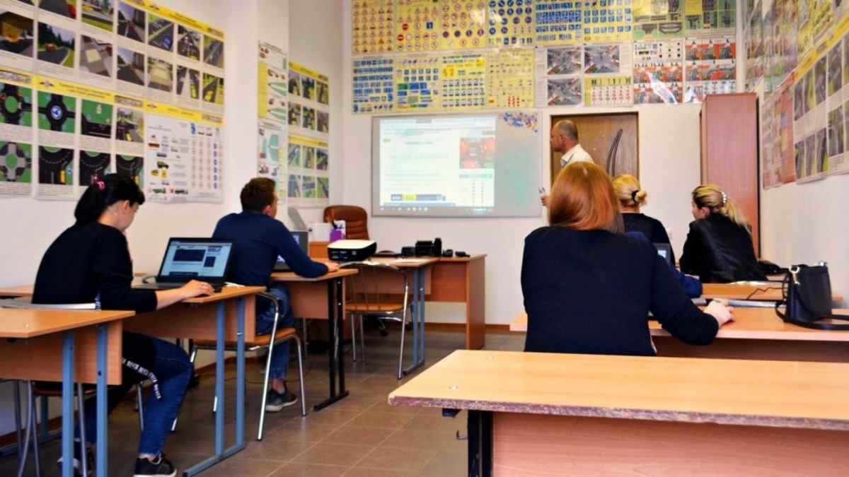 Alumnos en un aula realizando un curso teórico de seguridad vial para sumar puntos del carné de conducir.