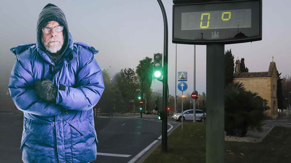 Hombre abrigado frente a un termómetro urbano marcando 0 grados en Madrid durante una mañana fría.