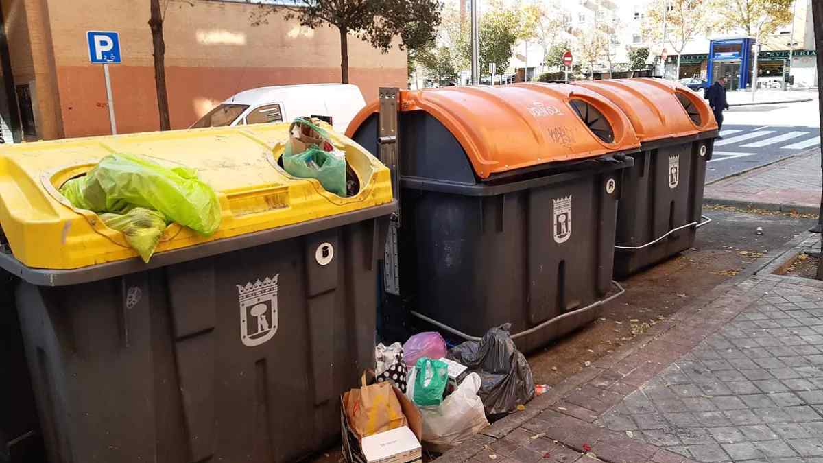 Contenedores de basura en Parla con bolsas de residuos fuera del contenedor