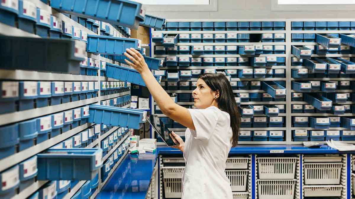 Farmacéutica revisando stock en oficina de farmacia tras la publicación de las nuevas tablas salariales 2025 y 2026
