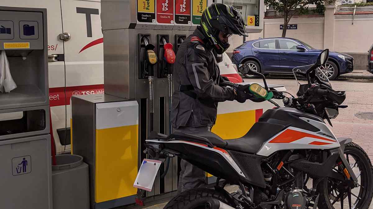 motorista repostando gasolina en gasolinera con multa dgt 100 euros