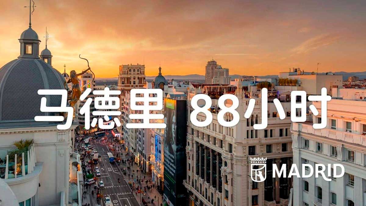Turismo chino en Madrid: cartel promocional con Gran Vía al atardecer y texto en chino