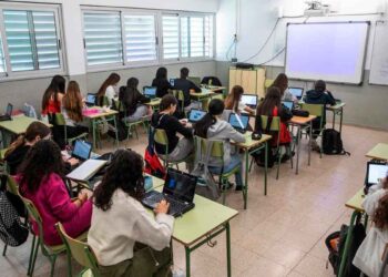 Alumnos en clase estudiando